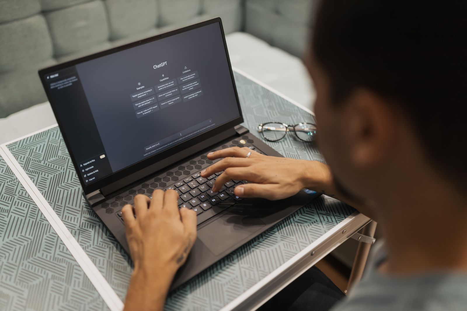 A person using ChatGPT on a laptop as a research tool