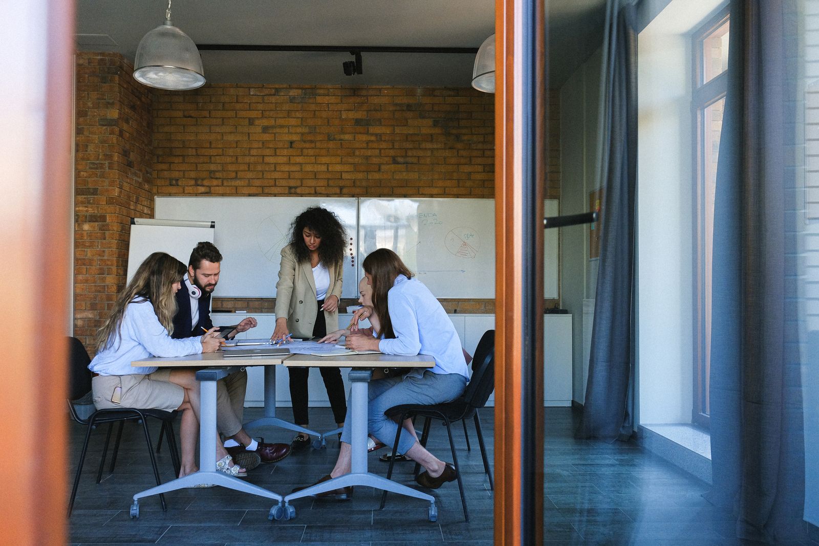 A group working together around shared documents at a table